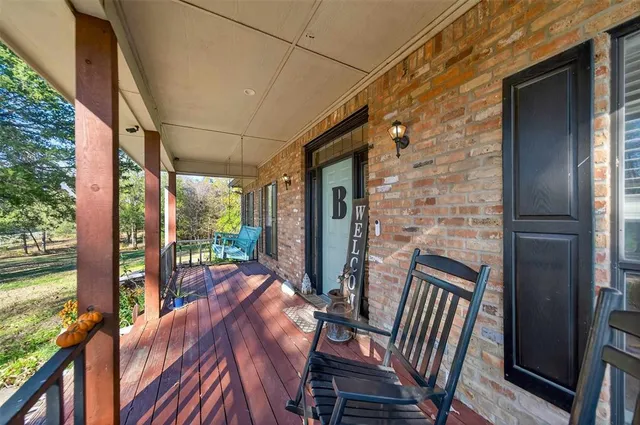 a view of balcony with wooden floor and outdoor seating