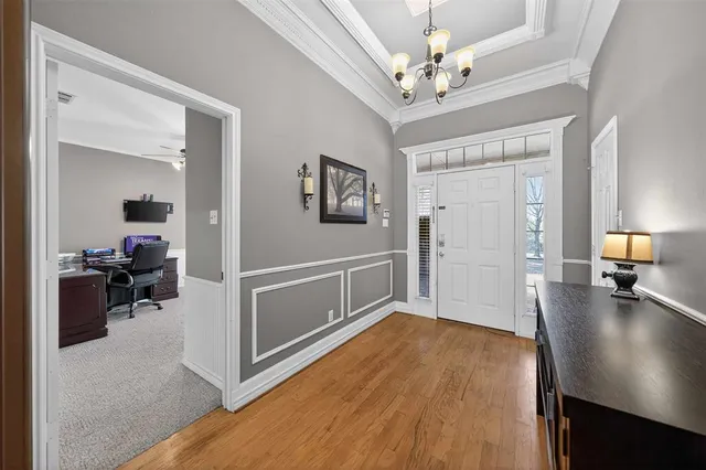 a view of a livingroom with furniture and a hallway