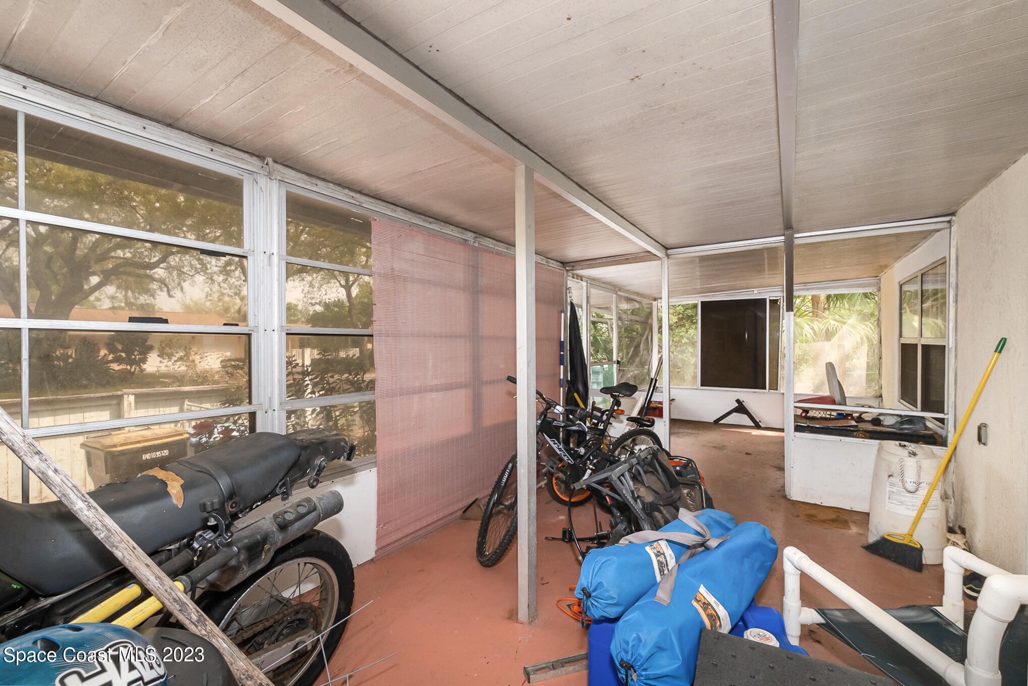 1826 Lemay Drive Northeast Palm Bay, FL 32905 - Photo 13 of 31 a room with furniture gym equipment and large windows