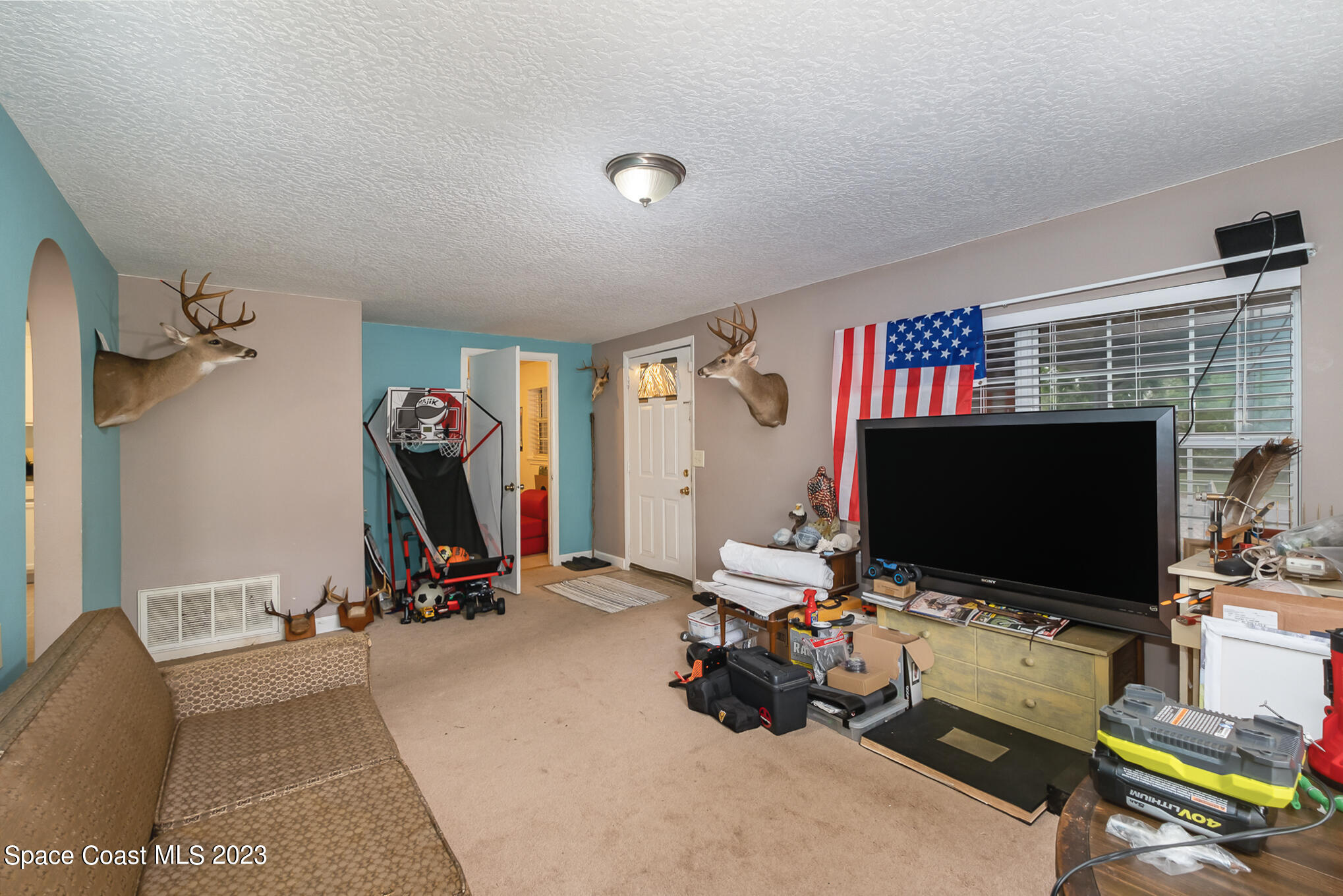 1826 Lemay Drive Northeast Palm Bay, FL 32905 - Photo 15 of 31 a room with furniture and a flat screen tv