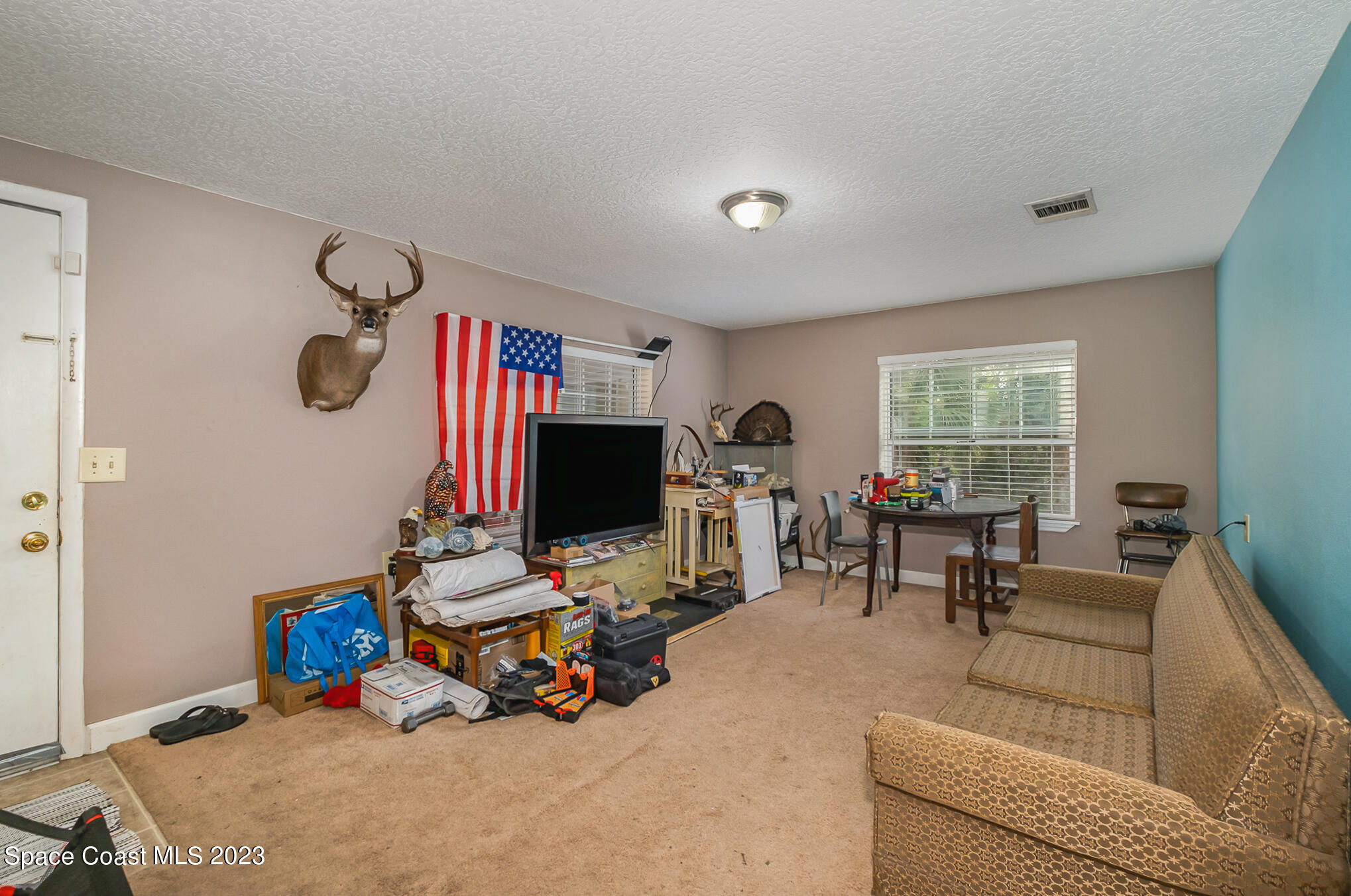 1826 Lemay Drive Northeast Palm Bay, FL 32905 - Photo 17 of 31 a living room with furniture and a flat screen tv