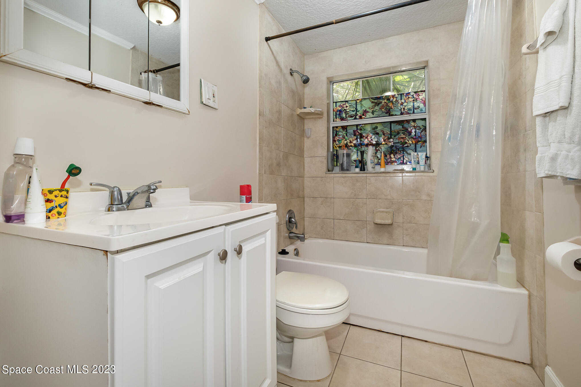 1826 Lemay Drive Northeast Palm Bay, FL 32905 - Photo 22 of 31 a bathroom with a sink a toilet and shower