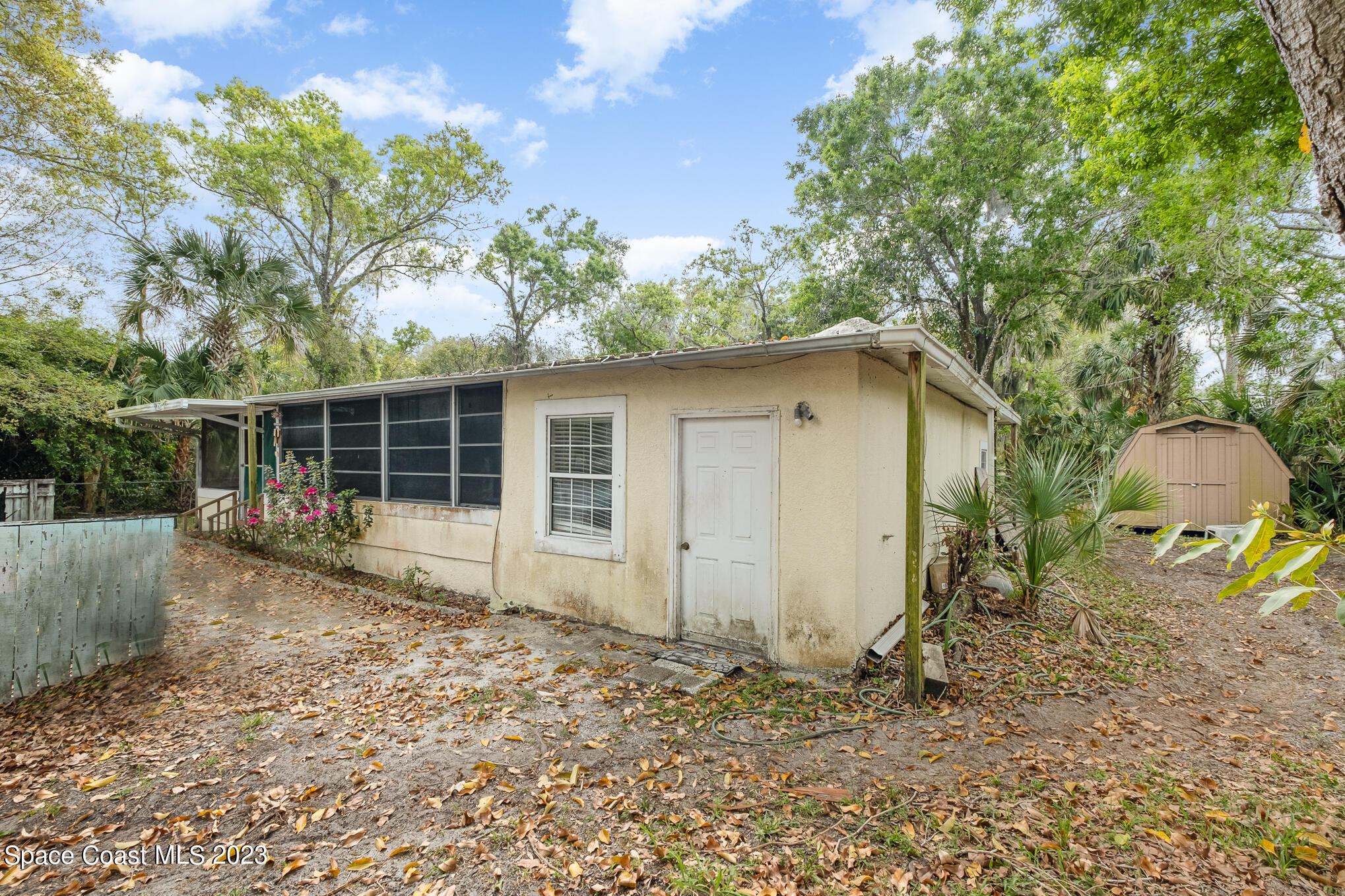 1826 Lemay Drive Northeast Palm Bay, FL 32905 - Photo 3 of 31 a backyard of a house with plants and outdoor seating