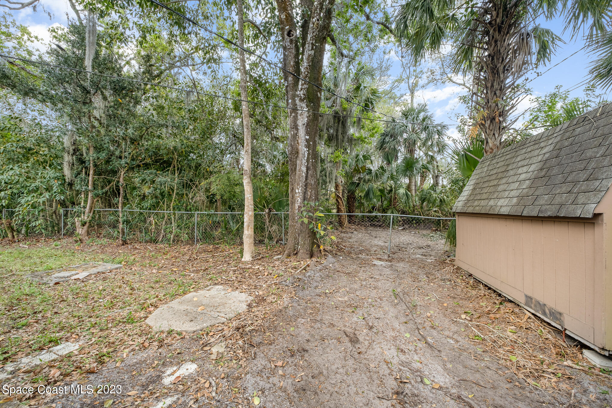 1826 Lemay Drive Northeast Palm Bay, FL 32905 - Photo 4 of 31 a backyard of a house with lots of green space