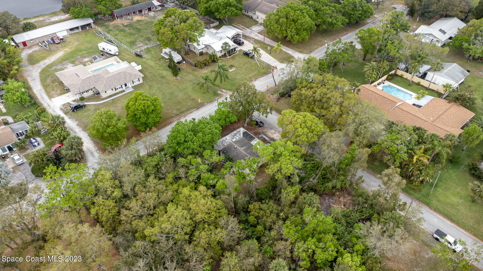 1826 Lemay Drive Northeast Palm Bay, FL 32905 - Photo 10 of 31 an aerial view of a house with a yard and lake view