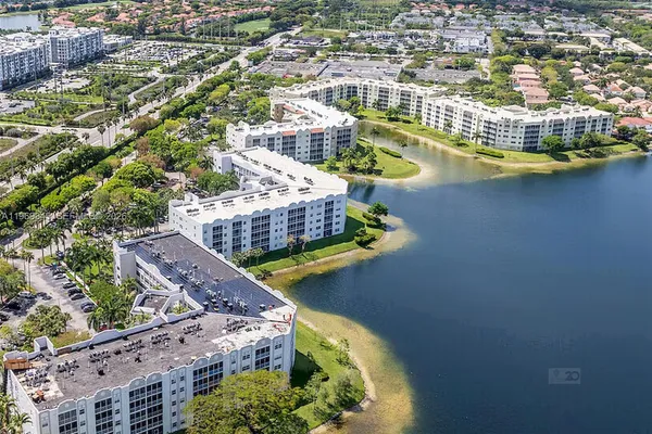 an aerial view of a residential houses with outdoor space and swimming pool