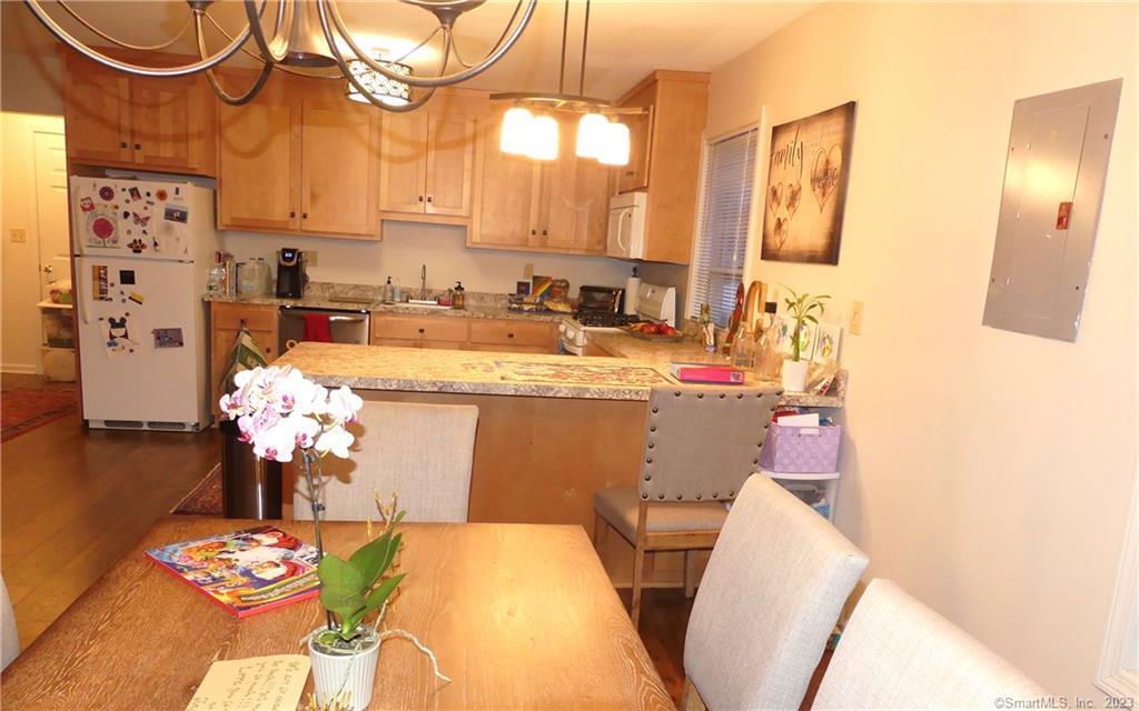 29 Boston Post Road Madison, CT 06443 - Photo 1 of 1 a dining room with stainless steel appliances furniture a chandelier and a mirror