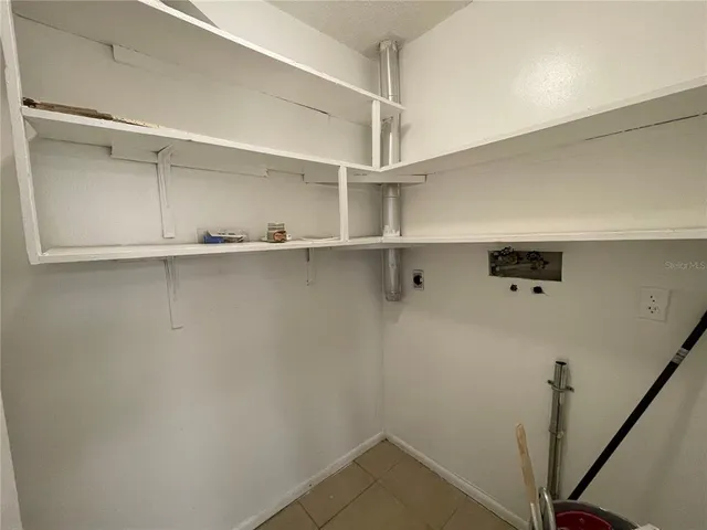 an empty room with closet and windows