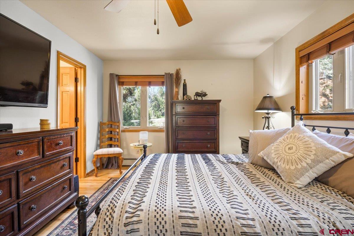 19016 Pinon Drive Cedaredge, CO 81413 - Photo 22 of 45 a bedroom with a bed and flat screen tv
