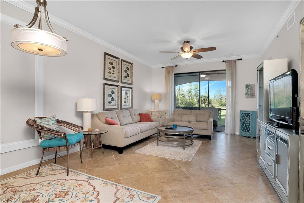 9719 Acqua Court, Unit 214 Naples, FL 34113 - Photo 2 of 50 a living room with furniture and a flat screen tv