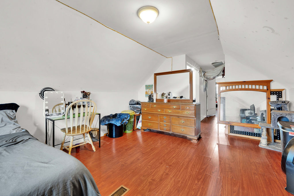 7234 South Ridgeway Avenue Chicago, IL 60629 - Photo 15 of 27 a bedroom with furniture and a wooden floor