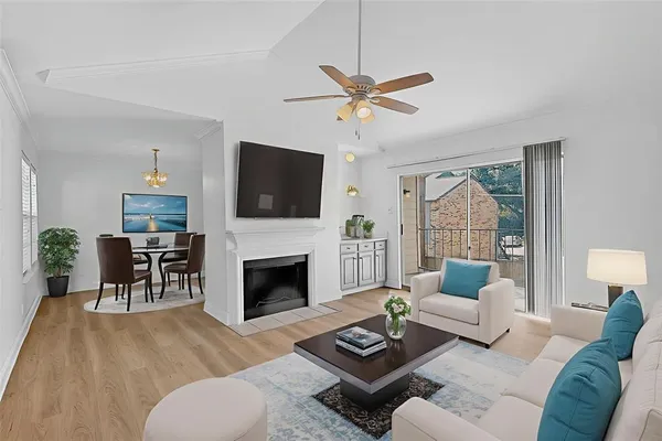 a living room with furniture a fireplace and a flat screen tv