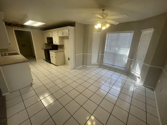 a view of a kitchen with furniture and an empty room