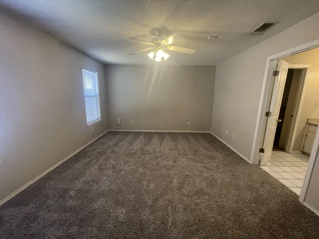 an empty room with windows and entrance