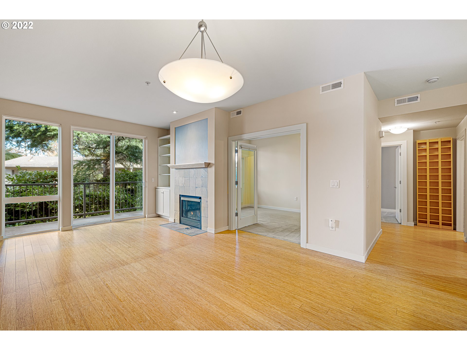 347 Rustic Place, Unit 8 Eugene, OR 97401 - Photo 14 of 31 a view of an empty room with a fireplace and a window