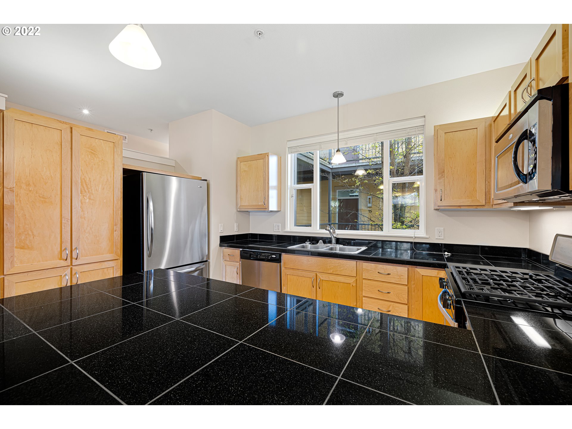 347 Rustic Place, Unit 8 Eugene, OR 97401 - Photo 4 of 31 a kitchen with granite countertop a stove a sink dishwasher and cabinets