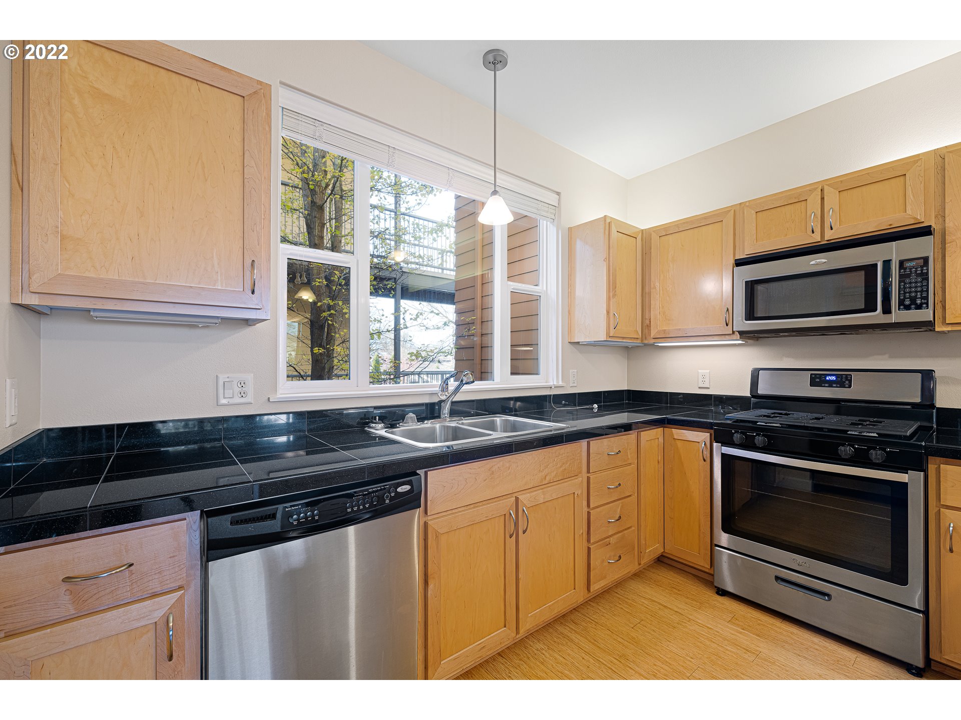 347 Rustic Place, Unit 8 Eugene, OR 97401 - Photo 5 of 31 a kitchen with granite countertop a sink a stove and cabinets