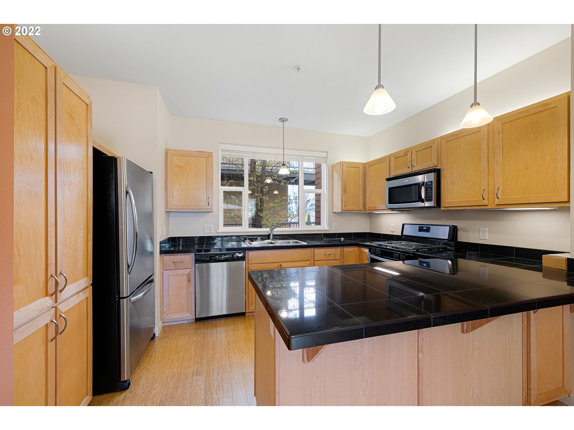 347 Rustic Place, Unit 8 Eugene, OR 97401 - Photo 6 of 31 a kitchen with stainless steel appliances granite countertop a sink refrigerator and microwave