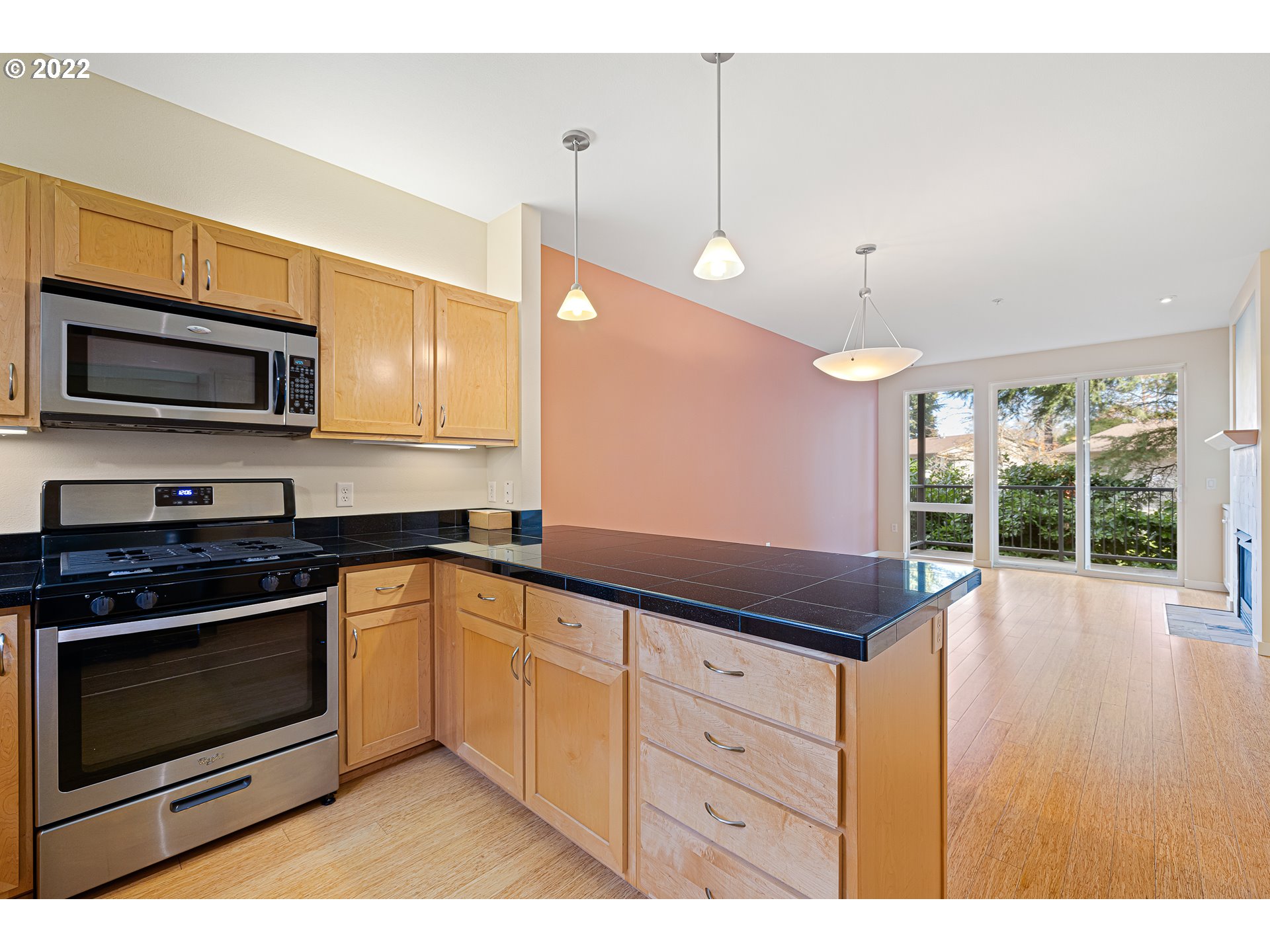 347 Rustic Place, Unit 8 Eugene, OR 97401 - Photo 7 of 31 a kitchen with granite countertop a stove a sink and wooden cabinets