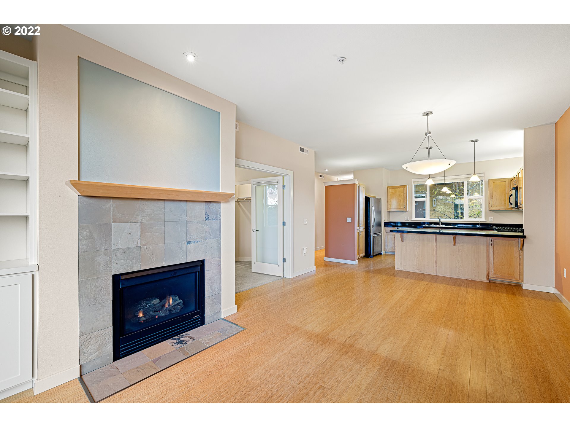 347 Rustic Place, Unit 8 Eugene, OR 97401 - Photo 9 of 31 a view of kitchen and empty room with fireplace
