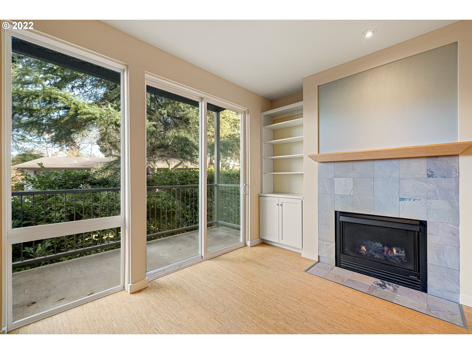 347 Rustic Place, Unit 8 Eugene, OR 97401 - Photo 10 of 31 a room with a fireplace and a floor to ceiling window