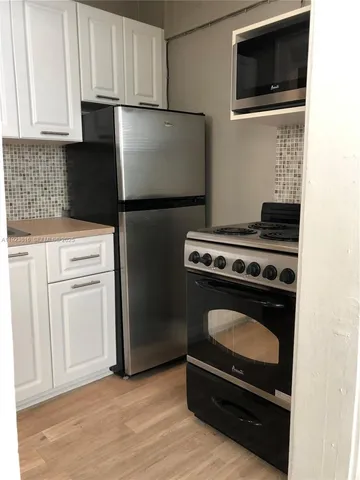 a kitchen with a stove and a microwave