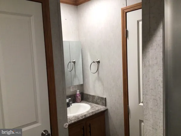 a bathroom with a sink vanity and mirror