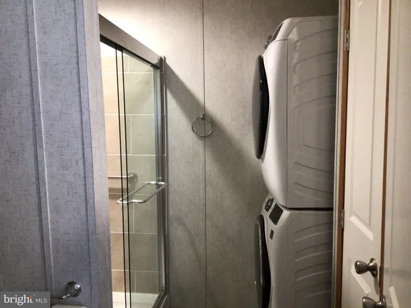 a bathroom with a glass shower door and a shower