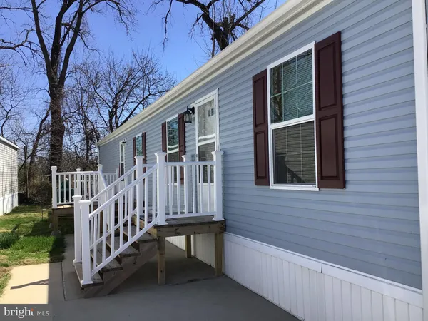 a view of backyard with deck and wooden fence