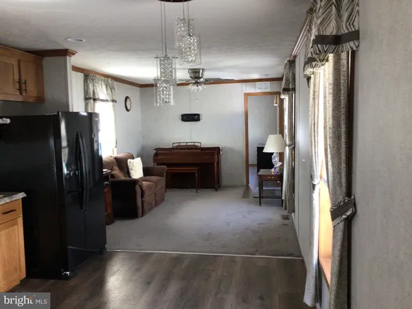 a view of a livingroom with kitchen and furniture