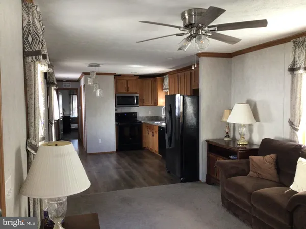 a kitchen with stainless steel appliances granite countertop a refrigerator a sink dishwasher a stove and a refrigerator