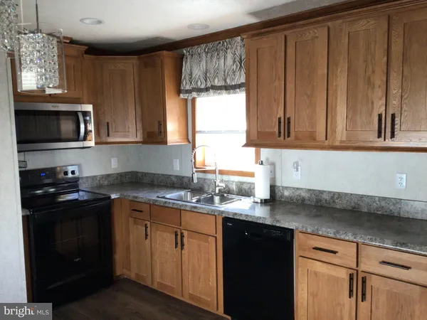 a kitchen with stainless steel appliances granite countertop a sink stove and microwave