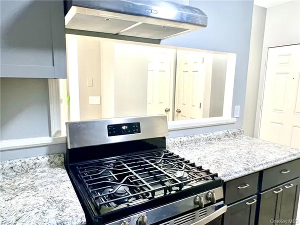a stove top oven sitting inside of a kitchen
