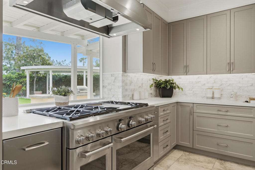 11543 Ragusa Drive Rancho Cucamonga, CA 91701 - Photo 27 of 69 a kitchen with stainless steel appliances granite countertop a stove and a sink