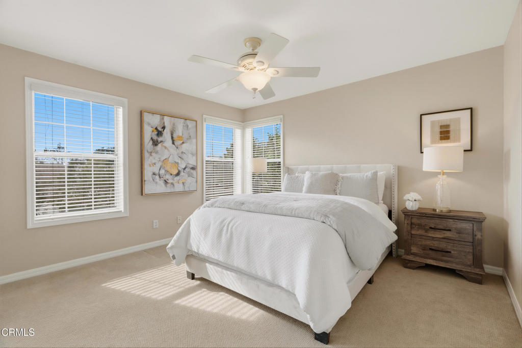 11543 Ragusa Drive Rancho Cucamonga, CA 91701 - Photo 31 of 69 a spacious bedroom with a bed a window and a chandelier