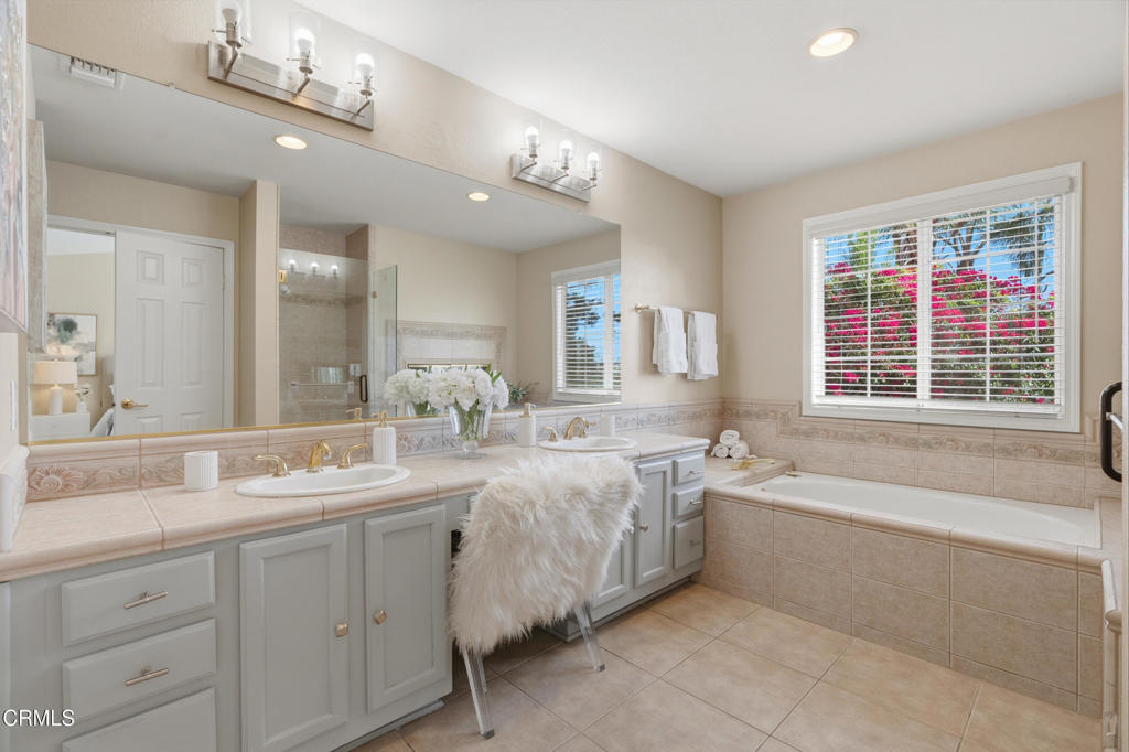 11543 Ragusa Drive Rancho Cucamonga, CA 91701 - Photo 43 of 69 a spacious bathroom with a double vanity sink large mirror and bathtub