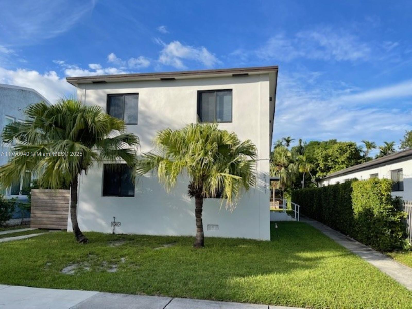 2141 Southwest 14th Terrace, Unit 4 Miami, FL 33145 - Photo 1 of 15 a front view of a house with garden