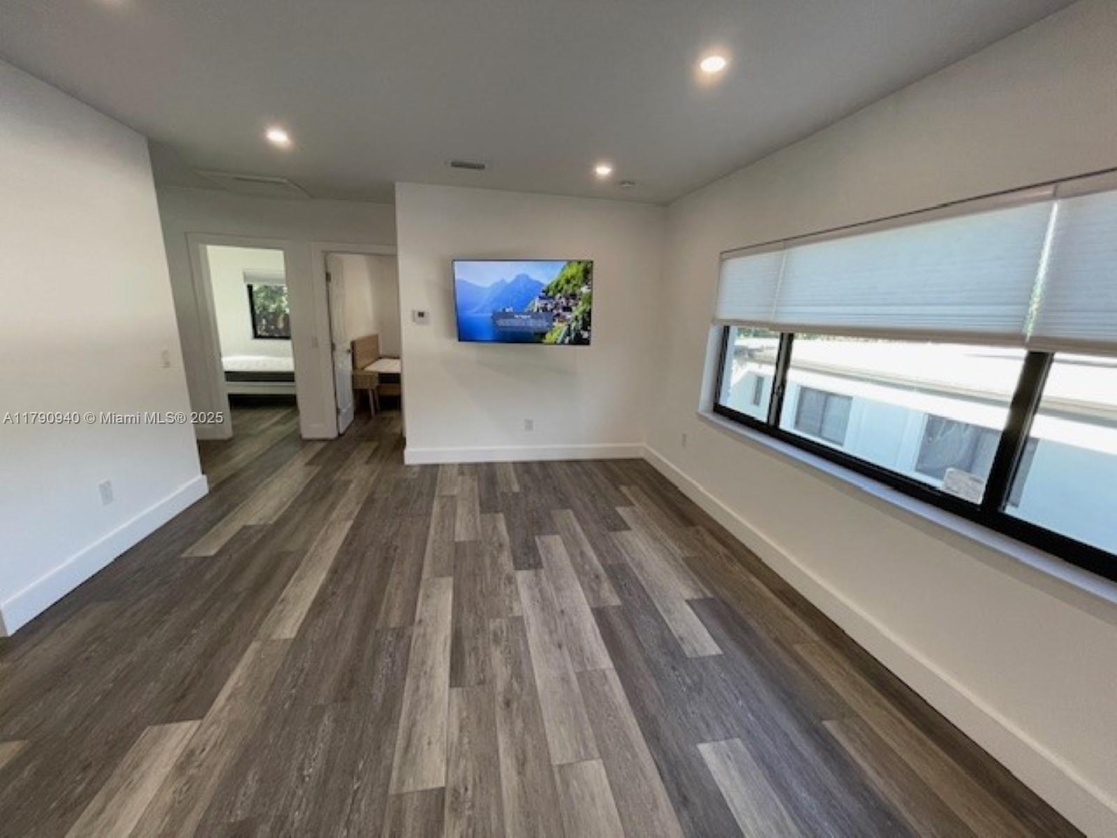 2141 Southwest 14th Terrace, Unit 4 Miami, FL 33145 - Photo 2 of 15 a view of a hallway with wooden floor and furniture