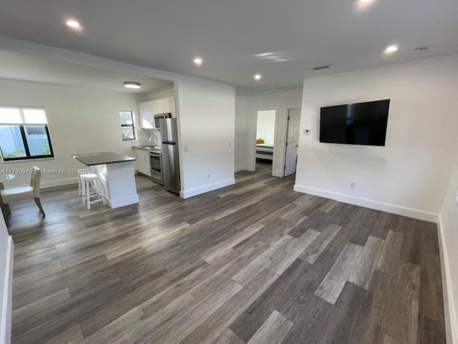 2141 Southwest 14th Terrace, Unit 4 Miami, FL 33145 - Photo 4 of 15 a living room with furniture and a flat screen tv
