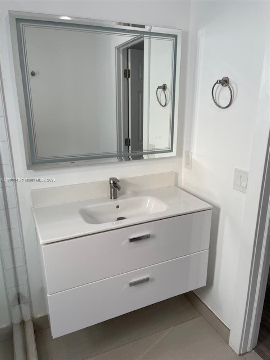 2141 Southwest 14th Terrace, Unit 4 Miami, FL 33145 - Photo 5 of 15 a bathroom with a sink and a mirror