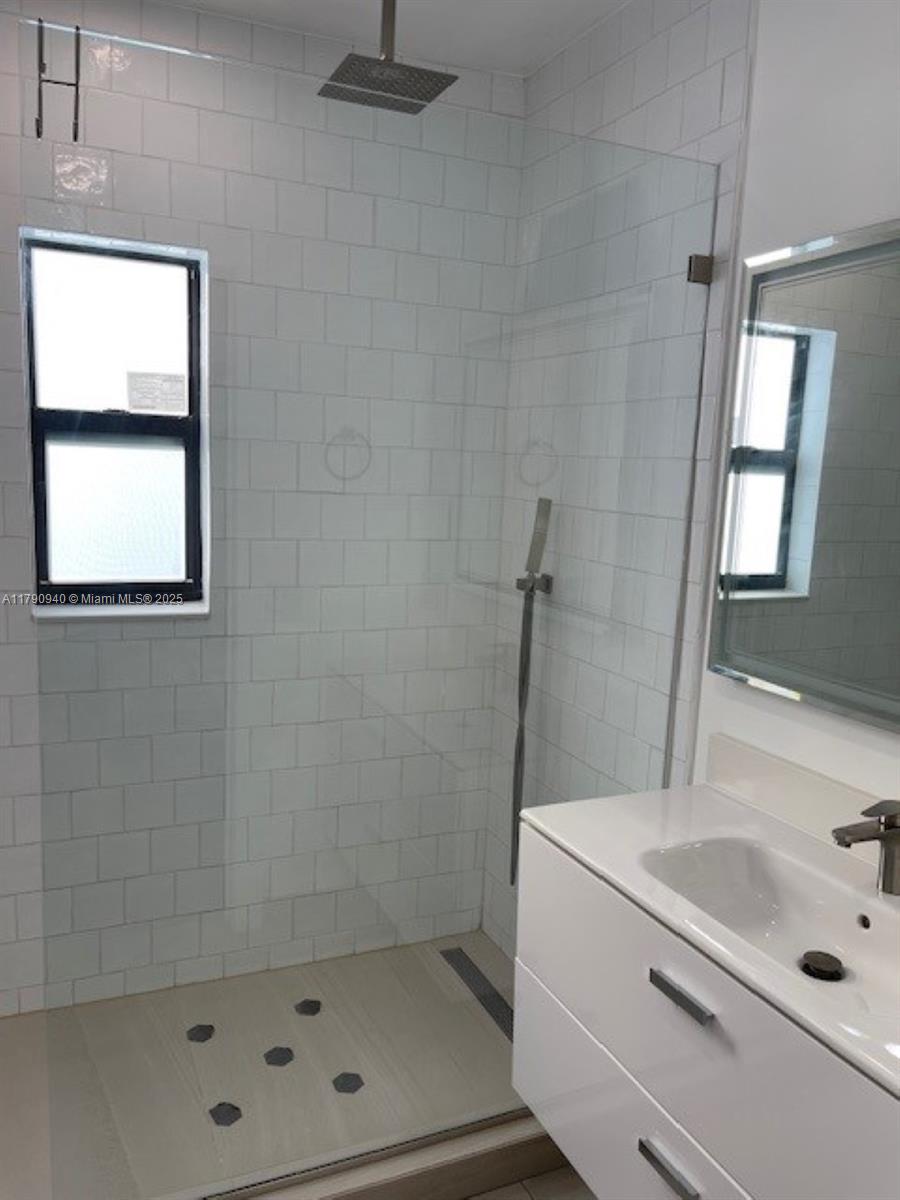 2141 Southwest 14th Terrace, Unit 4 Miami, FL 33145 - Photo 6 of 15 a bathroom with a sink a shower and a mirror
