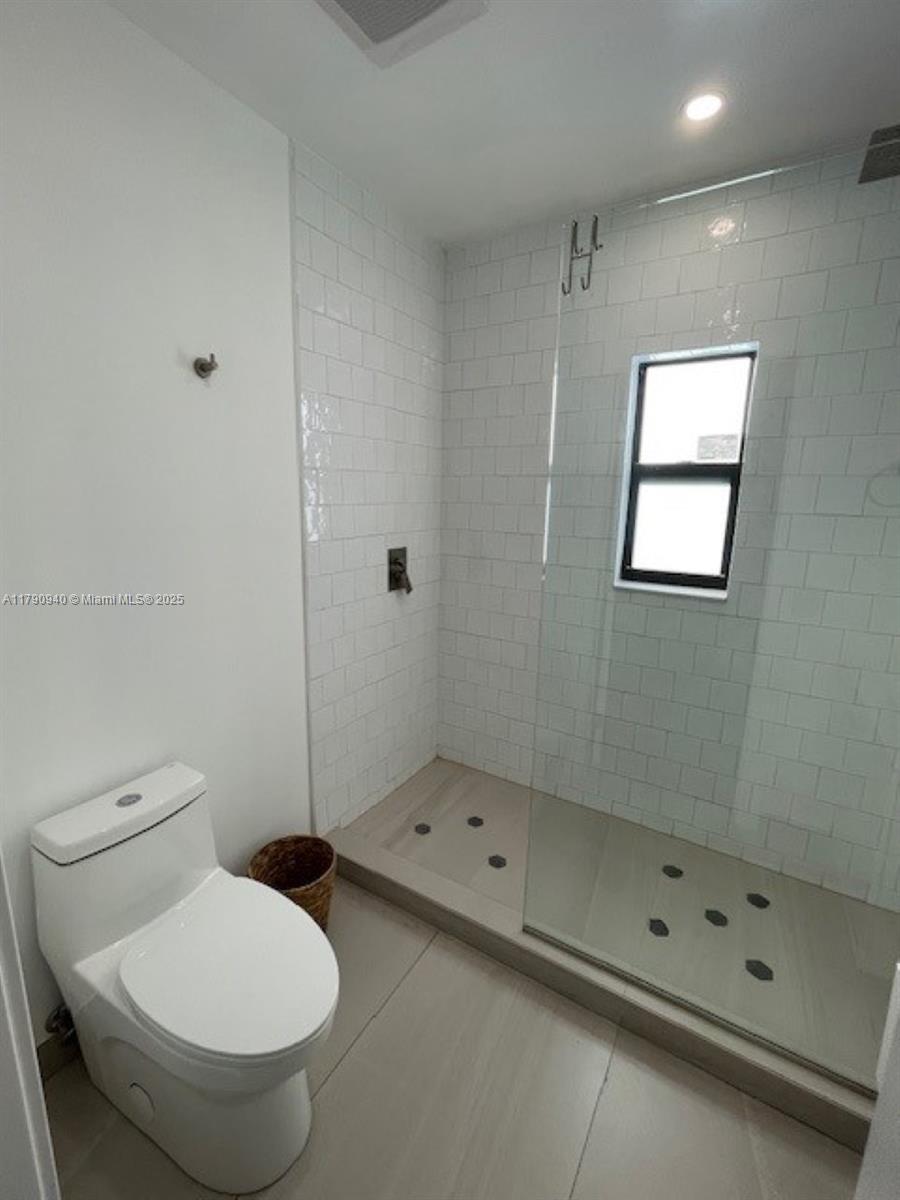 2141 Southwest 14th Terrace, Unit 4 Miami, FL 33145 - Photo 7 of 15 a bathroom with a toilet a sink and shower