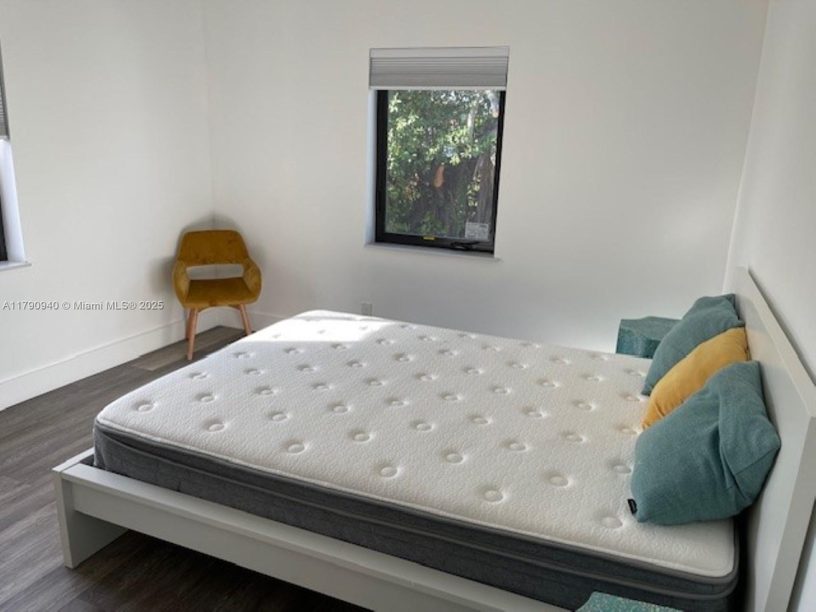 2141 Southwest 14th Terrace, Unit 4 Miami, FL 33145 - Photo 10 of 15 a bedroom with a bed and a painting on the wall