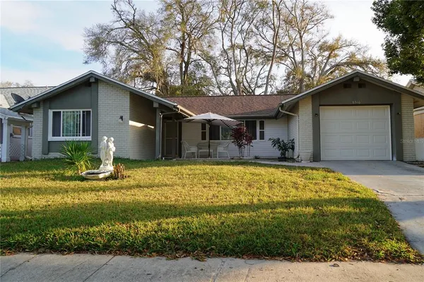 a front view of house with yard and green space