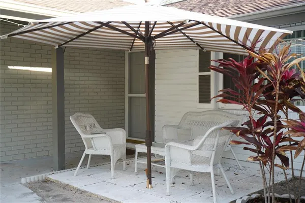 a view of a chairs and table in the patio
