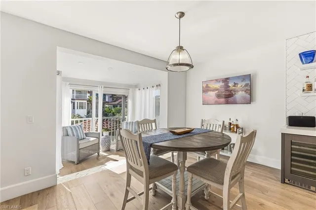 a view of a dining room with furniture wooden floor and chandelier