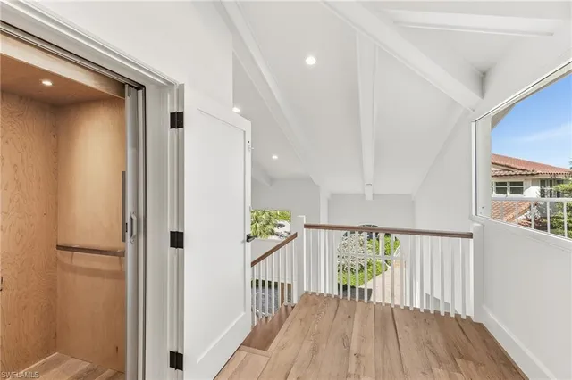 a view of hallway with wooden floor