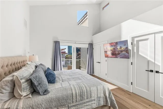 a bedroom with a bed and a large window