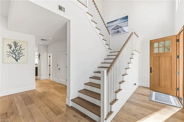 a view of a hallway with wooden floor and entryway