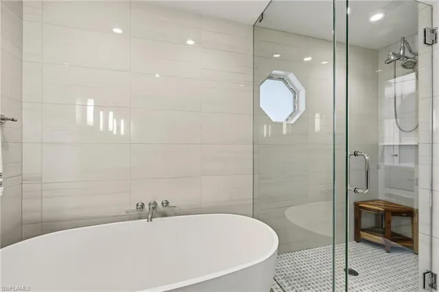 a bathroom with a bathtub and shower